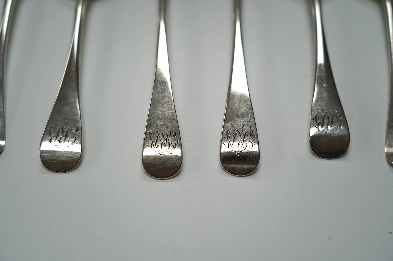 A pair of George III silver Old English pattern table spoons, Thomas Wallis II, London, 1798, 21.9cm and four earlier silver base mark table spoons, 14.3oz. Condition - poor to fair